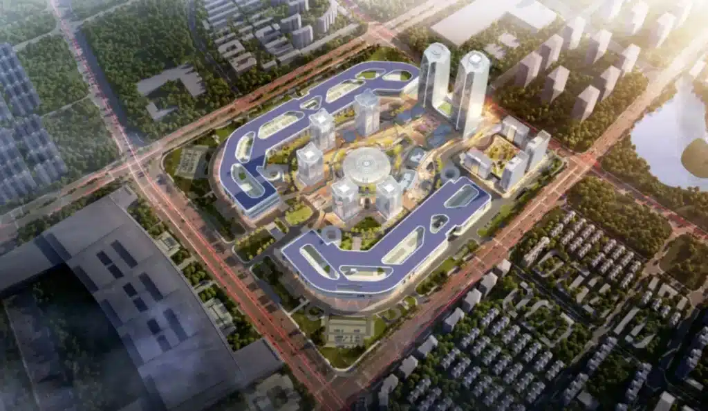Aerial view of a large, modern urban development featuring multiple buildings, green spaces, and road networks.