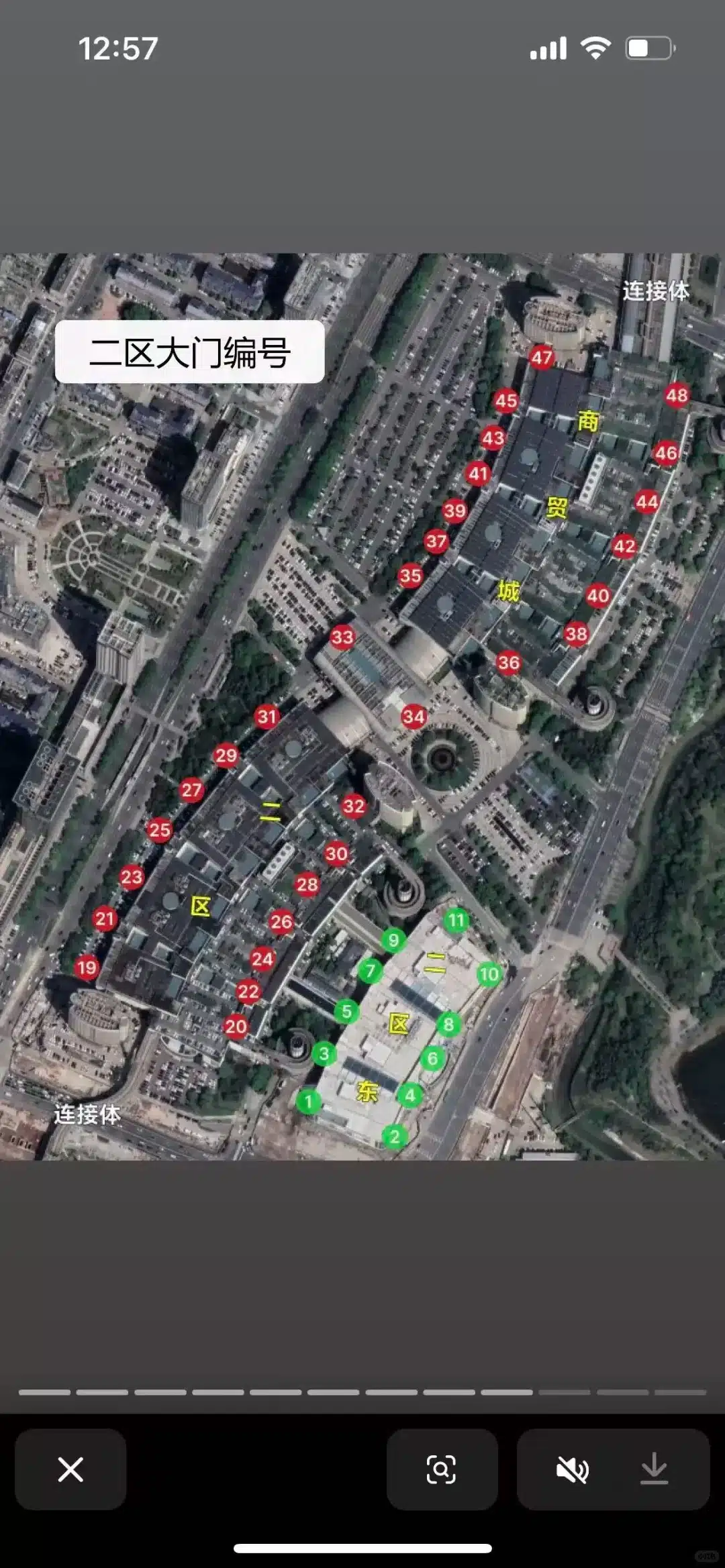 Satellite image showing a large building complex with parking areas labeled with numbers and some Chinese characters.