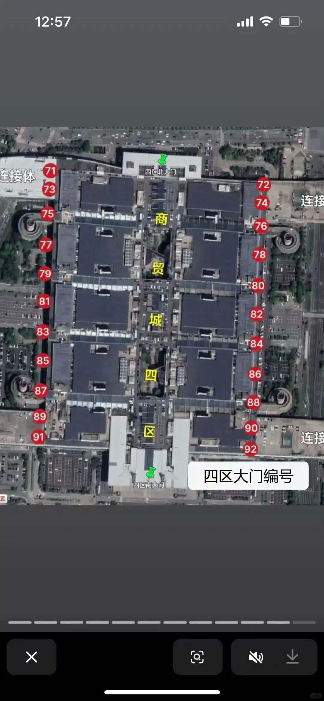 A satellite view of a large building complex with red numbered markers from 71 to 92. Text labels overlaid on the image.