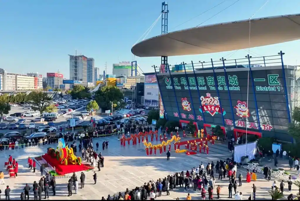 Crowd gathered for the opening ceremony at Yiwu International Trade Market with festive decorations and performances.