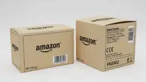 Amazon branded shipping boxes with labels and barcodes on a plain background.