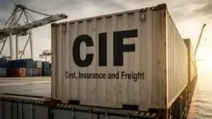 Shipping container with 'CIF Cost, Insurance and Freight' printed, situated at docks with cranes in the background.